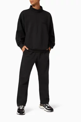 Buy Fear of God Essentials Black Relaxed Sweatpants in Fleece for