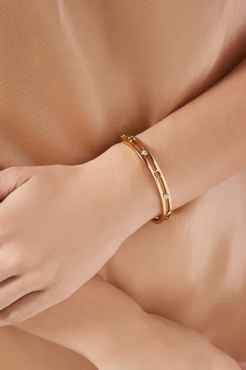 سوار بتصميم مفرغ بشعار الماركة مرصع بأحجار نحاس ذهبي اللون