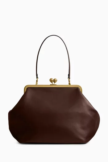 حقيبة كبيرة بقفل متقاطع وإطار جلد