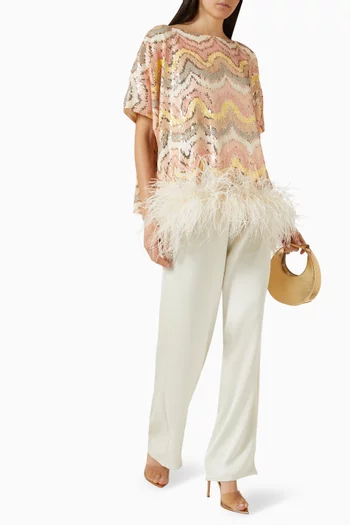 بلوزة بقصة واسعة مزينة بنقشة مموجة وتطريزات بالترتر