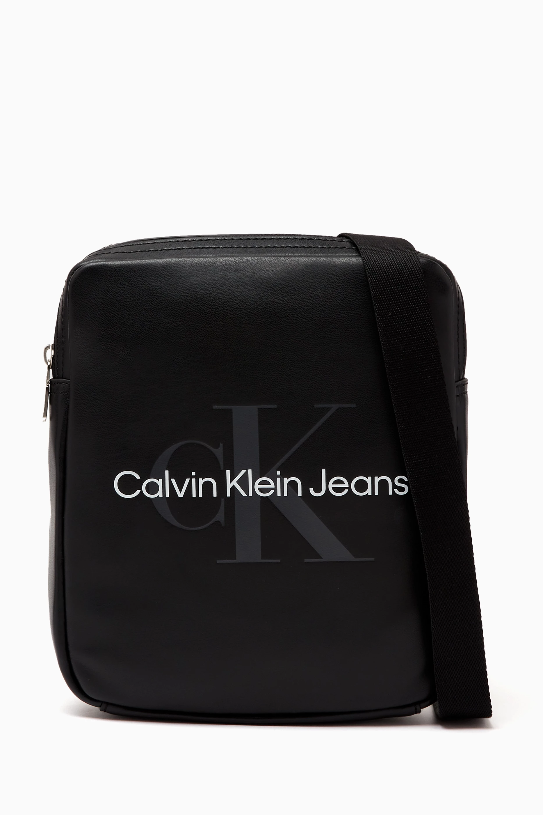 Buy Calvin Klein Jeans Black Logo Print Reporter Bag in Faux Leather for Men in UAE Ounass