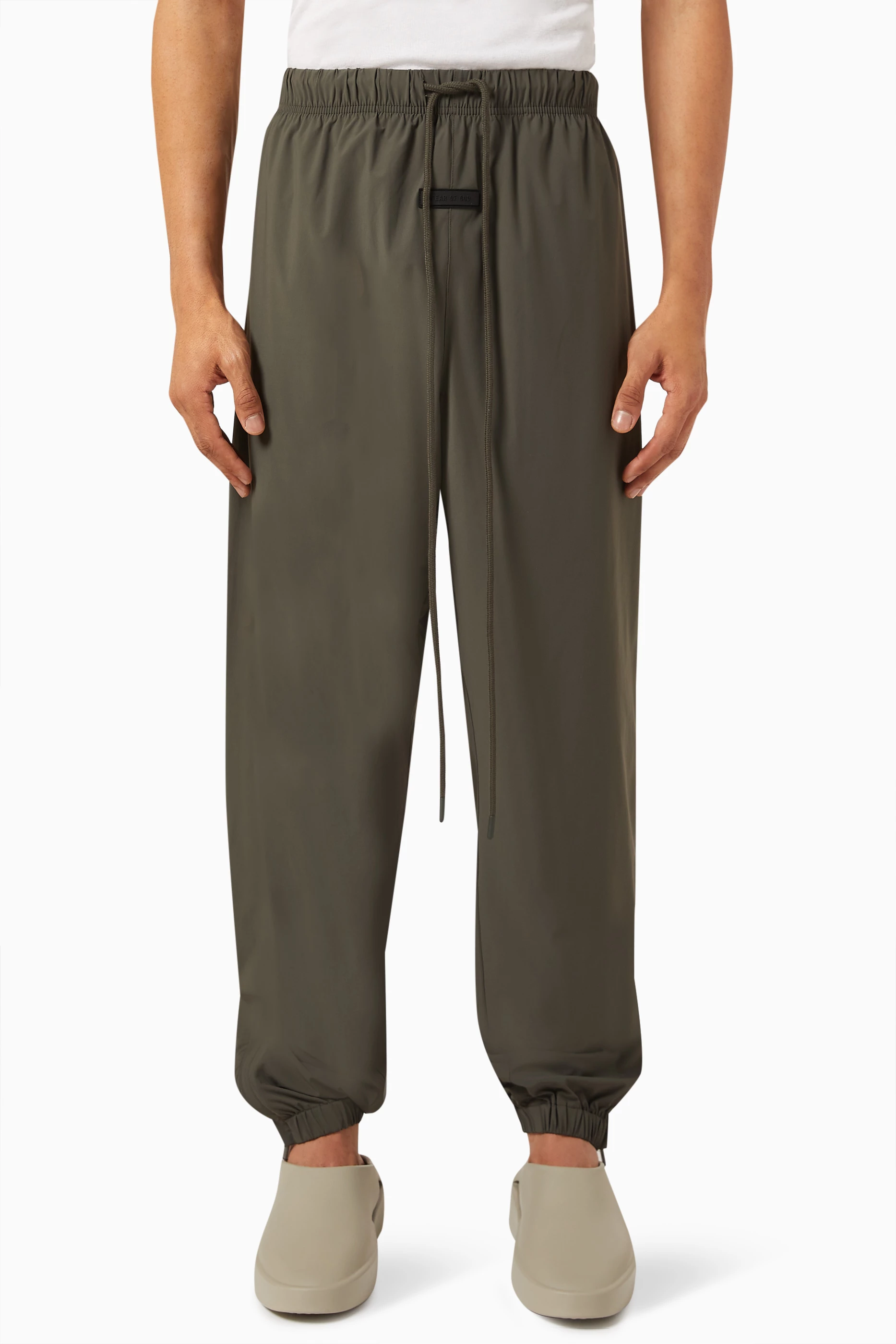 Buy Fear of God Essentials Grey Logo Trackpants in Stretch Woven
