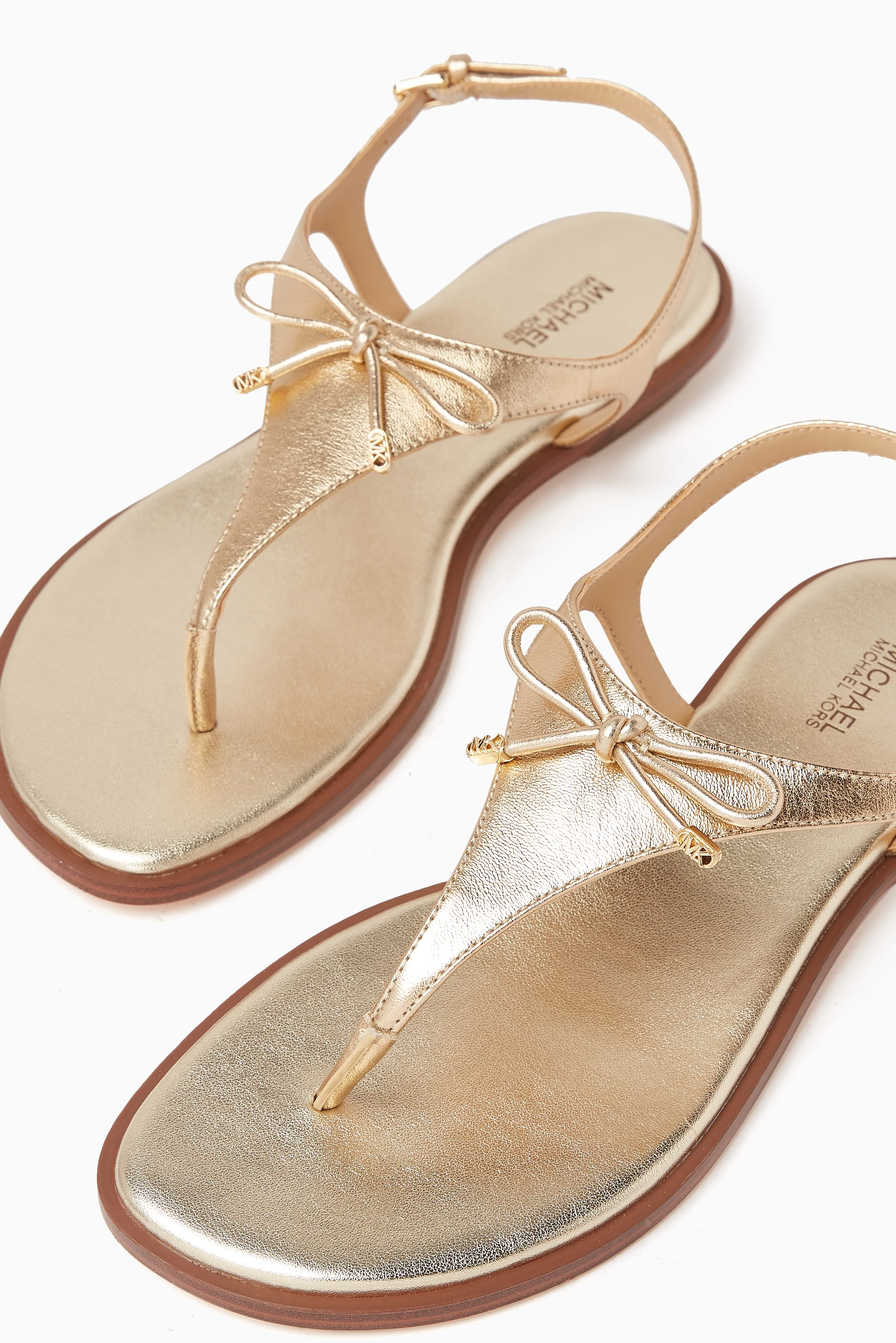 Buy Michael Kors Gold Nori Flat Thong Sandals in Shiny Leather for