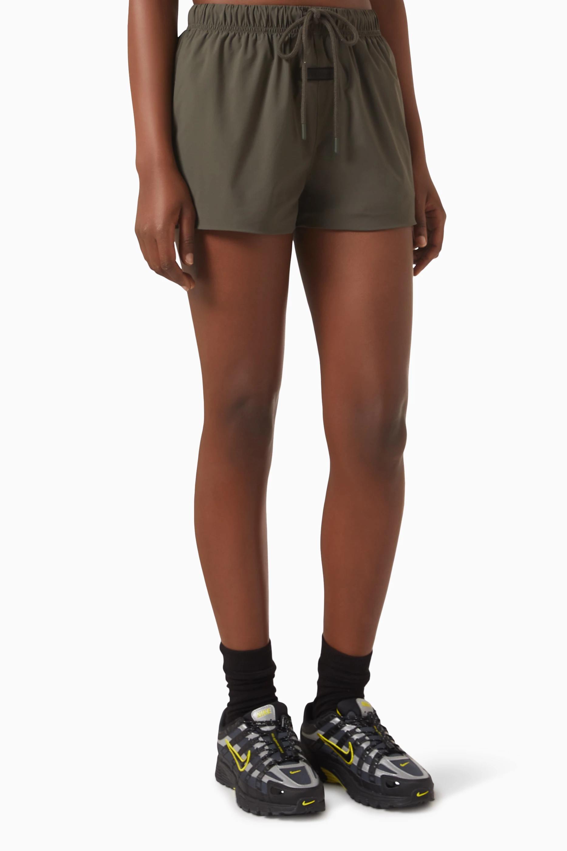Buy Fear of God Essentials Black Running Shorts in Stretch Woven Nylon For Women Online Ounass UAE